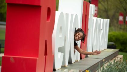  Camryn Harrell waves from inside one of the letters at the Revolutionary monument on Busch campus