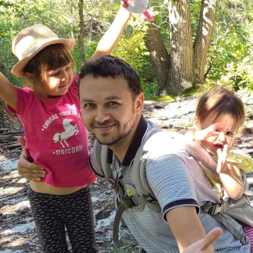 Leonid Yanchis posing with his 2 daughters